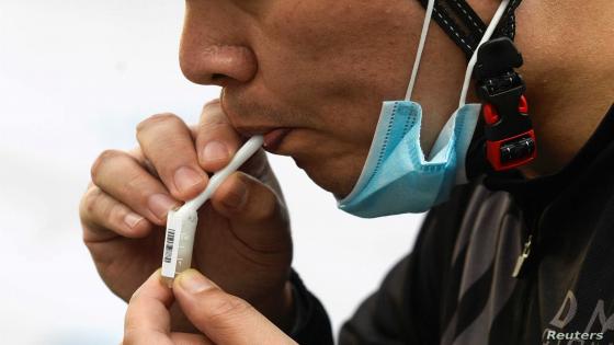 A man collects his own saliva sample in a vial at a drive-thru coronavirus disease (COVID-19) saliva testing site, in Pasay city, Metro Manila, Philippines, February 3, 2021. REUTERS/Lisa Marie David