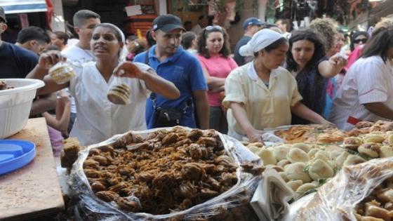 People are seen buying Moroccan pastries on the first day of the holy month of Ramadan in Rabat on August 22, 2009. The start of the ninth and holiest month of the Muslim calendar is traditonally determined by the sighting of the new moon, often dividing rival Islamic countries and sects over the exact date. During Ramadan, Muslims are required to abstain from food, drink and sex from dawn until dusk as life slips into a lower gear during the day. Muslims entered the fasting and feasting month of Ramadan with swine flu and the economic downturn adding to security fears in several Islamic countries in dampening the mood. AFP PHOTO/Abdelhak Senna / AFP PHOTO / ABDELHAK SENNA